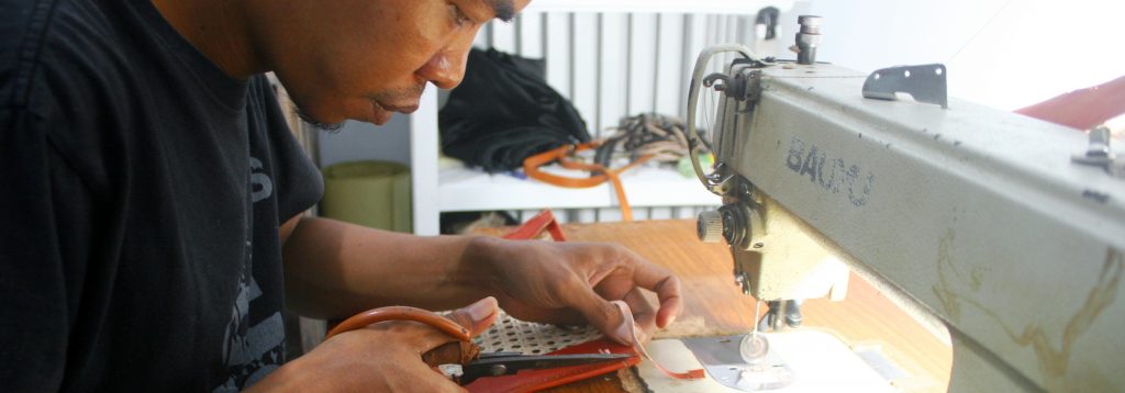 Hakim making a leather bag